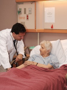 Older woman in bed at nursing home