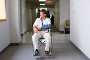 Man in wheelchair with a broken arm