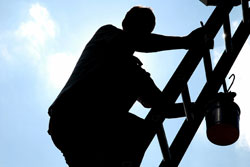 Construction worker climbing ladder