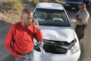 Man talking on phone after car accident